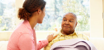 caregiver assisting elderly man