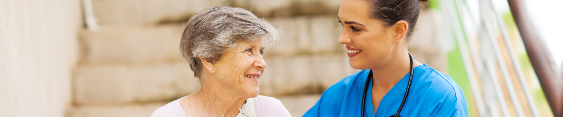 caregiver assisting an elderly lady